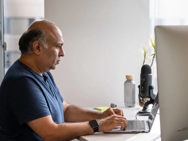 Man sitting at a desk working on his computer